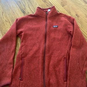 Red Patagonia jacket with a lot of pockets
